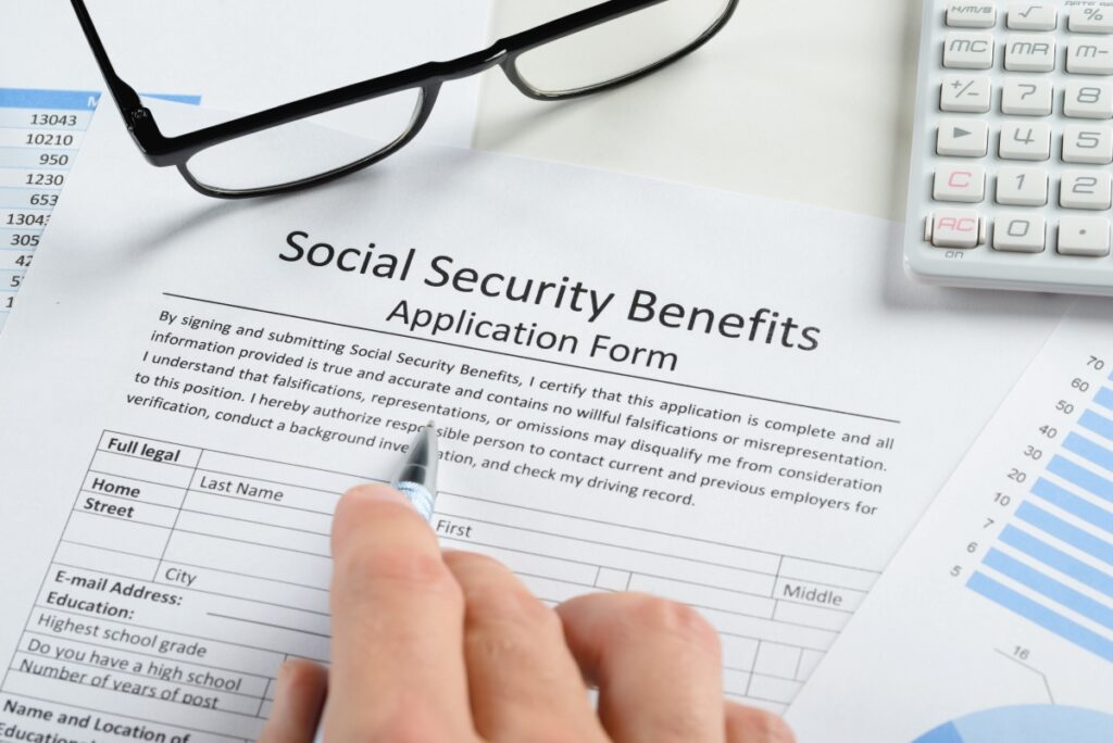 Image of a social security form with a calculator in the background